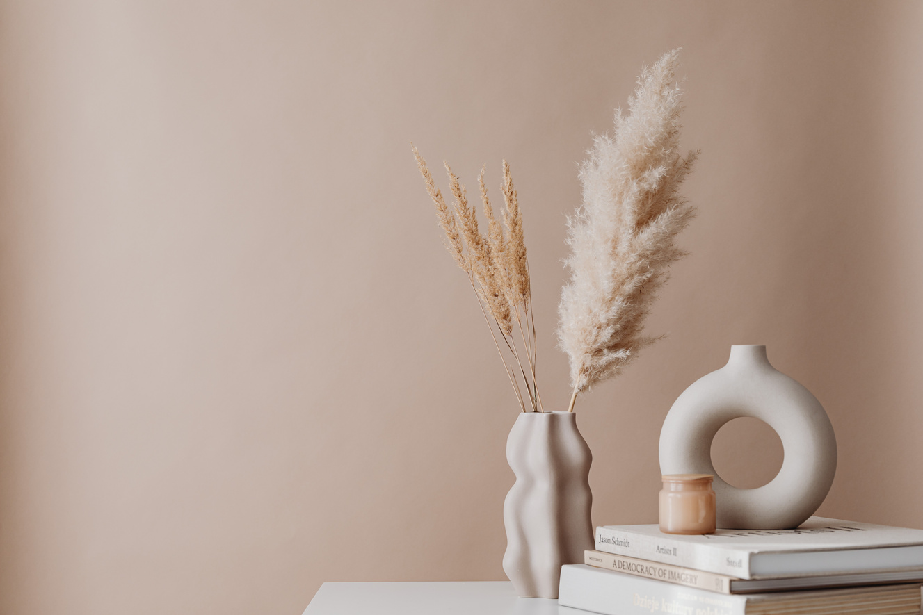 Beige Minimalistic Decor - Dry Grass in a Vase, Candle and Books